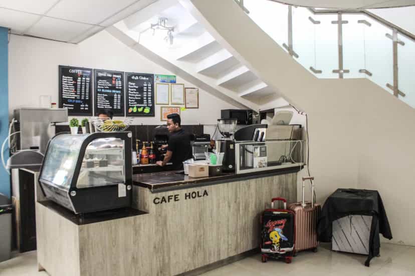 Full view of the CAFE HOLA counter — grab a drink with your luggage still in tow