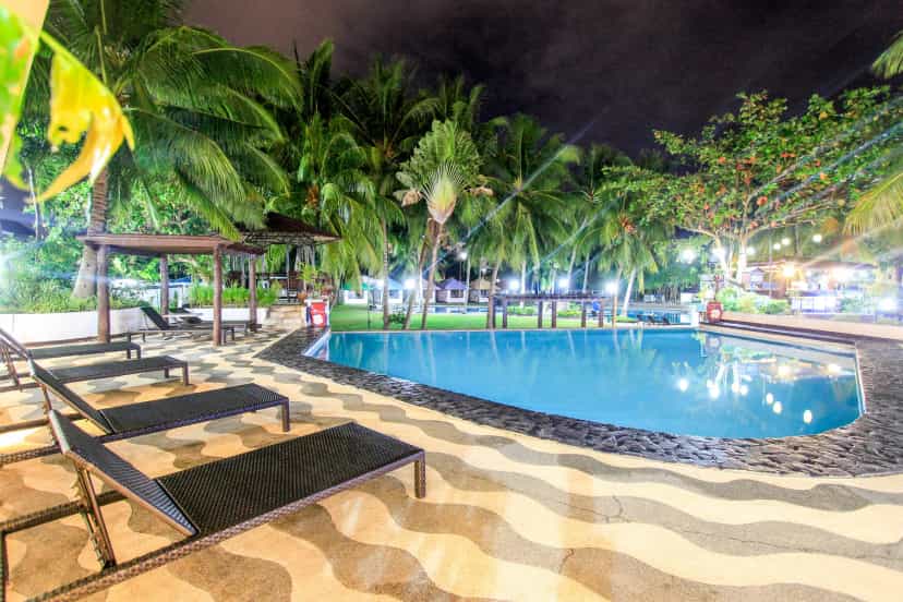 The pool lit up at night—quiet and romantic