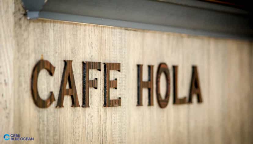 Carved wooden sign of the on-campus café CAFE HOLA