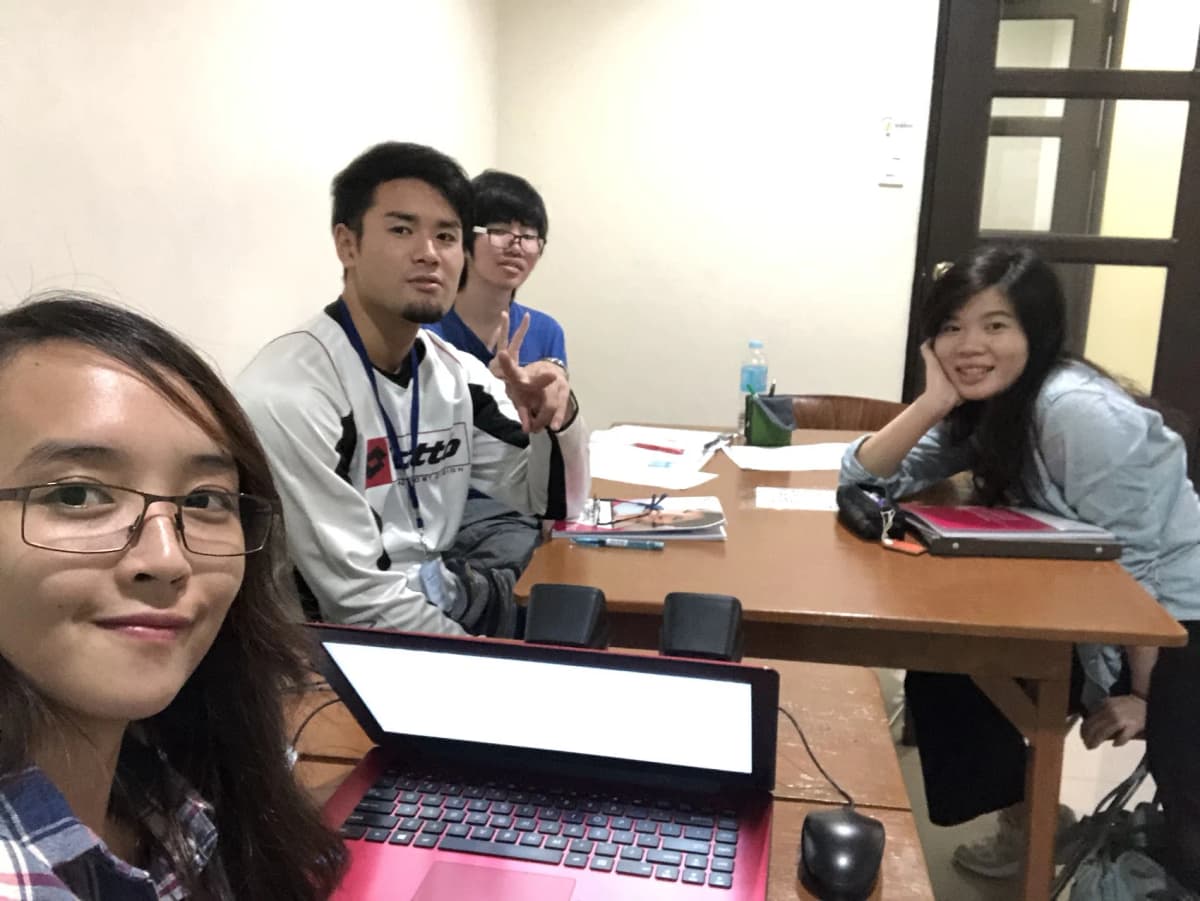 A selfie with teachers and classmates around a table in a PINES classroom